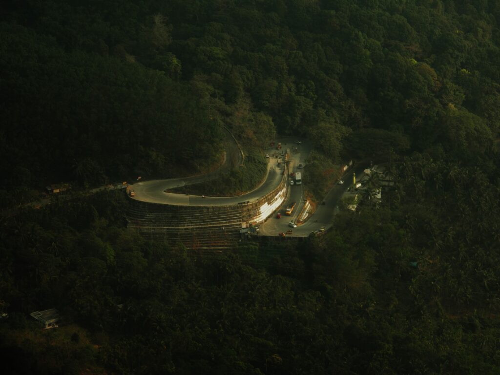 A scenic aerial view of a winding road through the dense forests of Wayanad, India.This beautiful ghat near on the BREWTOPIA cafe in wayand