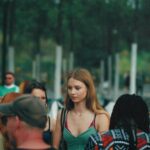 Group of diverse young adults socializing outdoors in a Berlin park.